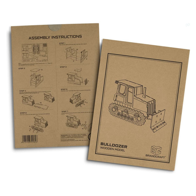 A cardboard package featuring assembly instructions for a wooden bulldozer model, with illustrations and a logo.