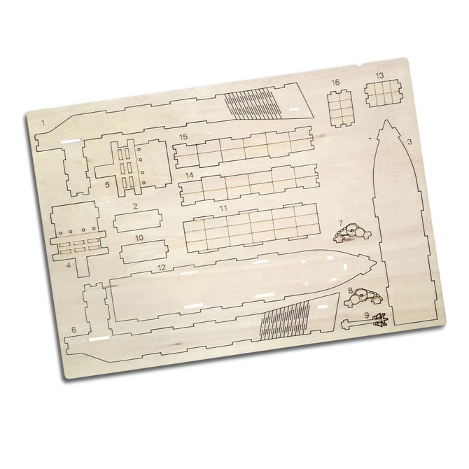 A wooden model kit of a cargo ship, featuring various pre-cut pieces on a light wooden background.