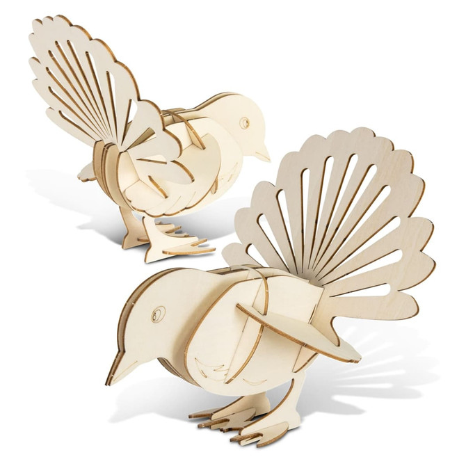 A wooden model of a fantail bird in natural colour, featuring intricate cut-out detailing and a three-dimensional design.