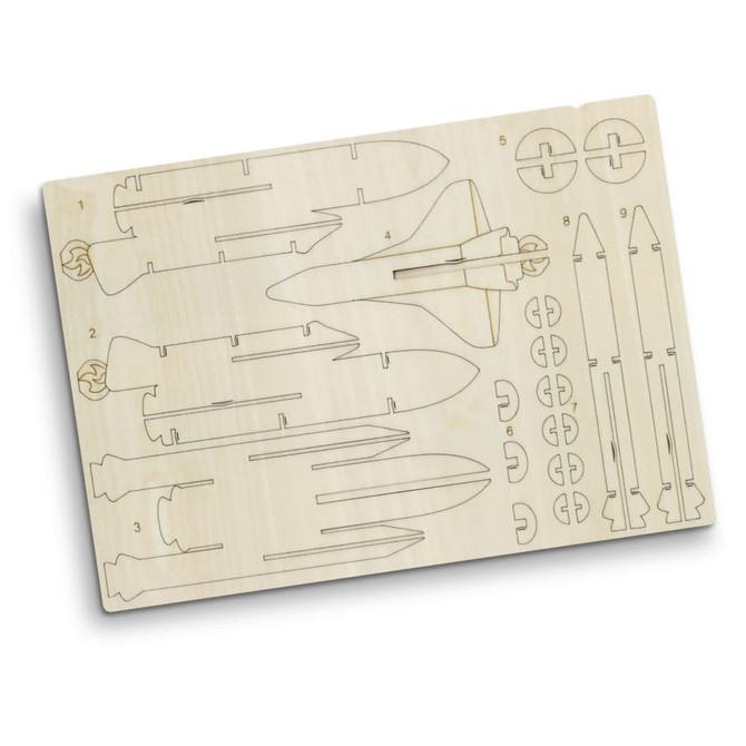 A wooden model kit featuring rocket ship components with various shapes, set on a light-coloured wooden sheet.