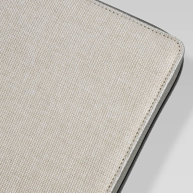 A textured beige cover of a portable drawing set with a black edge. Features a branding logo.
