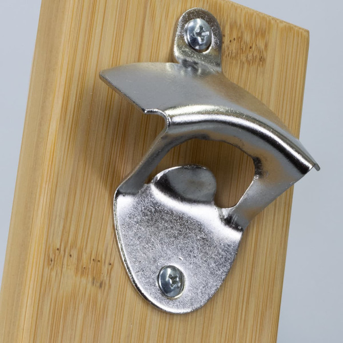 A drink bottle opener with a stainless steel finish mounted on a bamboo backboard. Features a small logo.