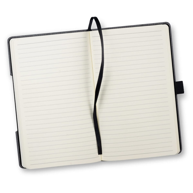 An open Atoll Notebook featuring lined pages, a black cover, and a black ribbon marker.