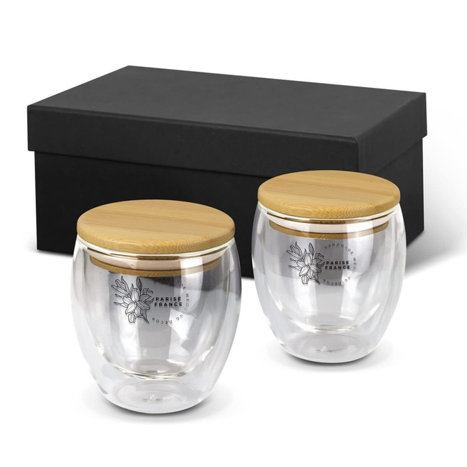 A drinkware set featuring two clear glass mugs with bamboo lids, presented in a black box.