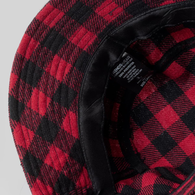 A red and black checked bucket hat with a soft inner lining and a care label inside.
