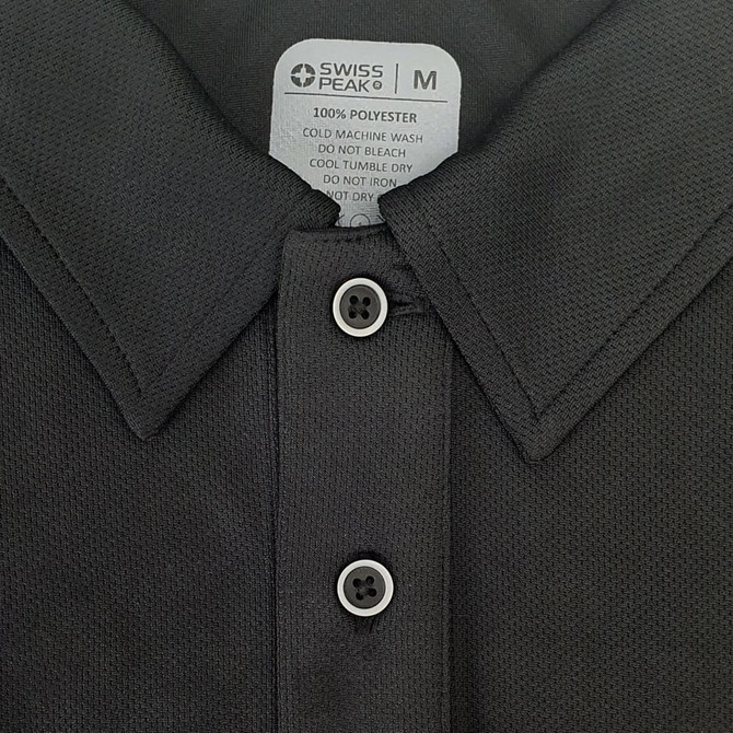 A black polo shirt featuring a collar and three buttons, labelled with care instructions and a brand logo.
