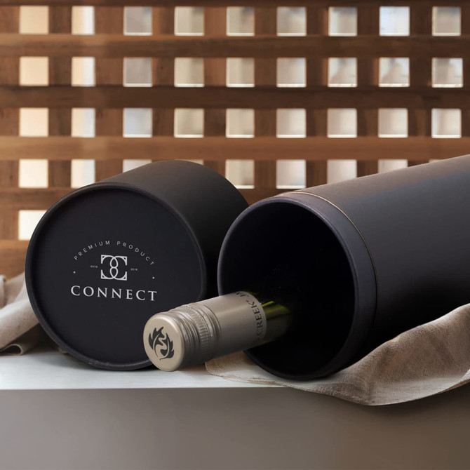 A wine bottle gift tube in matte black with a wine bottle partially visible inside, featuring a logo on the tube.