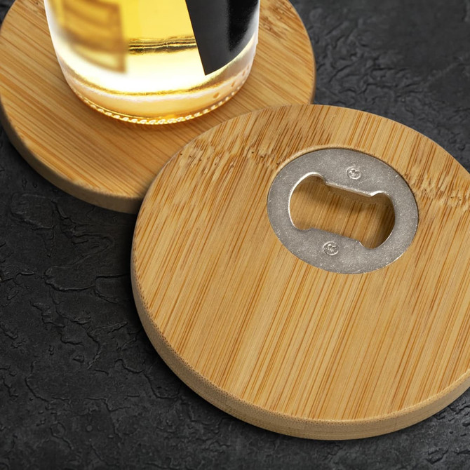 A drink bottle rests on two round bamboo coasters, each featuring a metal bottle opener in the centre.