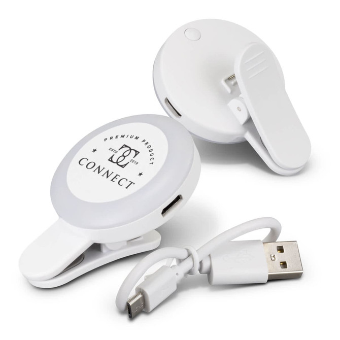 A white selfie light with a clip and USB charging cable, designed for mobile phones. It features a branded logo.