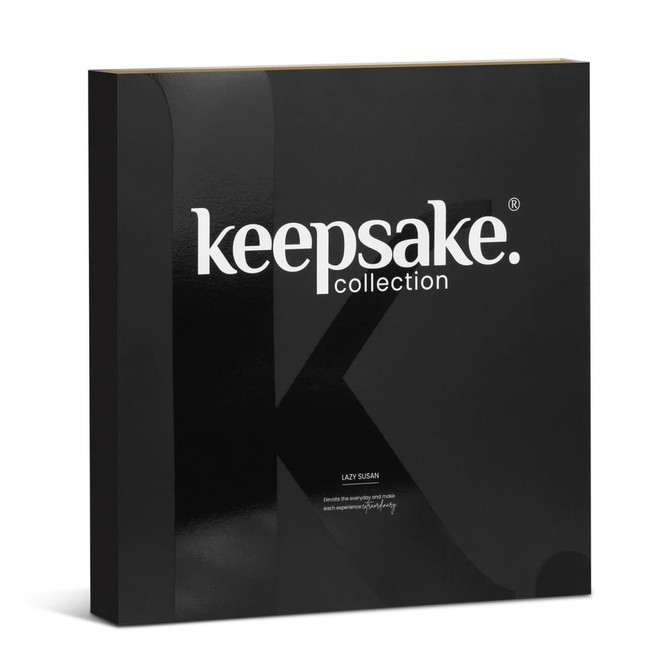 A black box containing the Keepsake Lazy Susan product. The box features a glossy finish and has a logo.