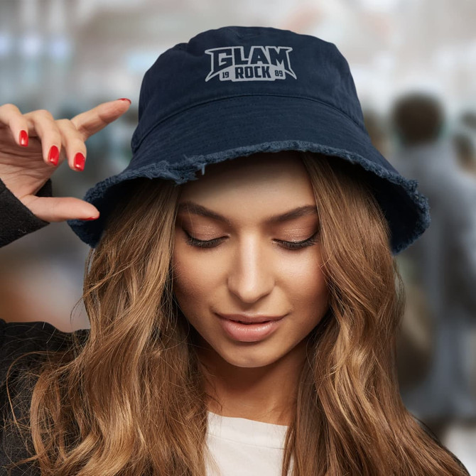 A woman wearing a navy blue Raw Edge Bucket Hat with a logo on the front and frayed edges.