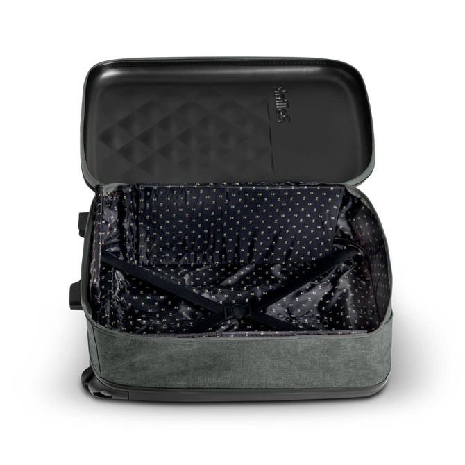 A small green wheeled suitcase with an unzipped black interior featuring a patterned lining. The suitcase has a logo.