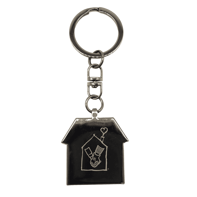 A gunmetal keychain in the shape of a house, featuring a decorative design and a metal ring.