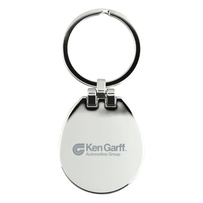 A silver keychain with a rounded shape and a ring, featuring a logo on one side.