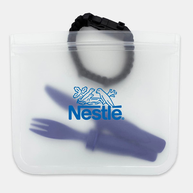 A clear PEVA reusable food storage bag containing a green fork and knife, with a black wristband visible inside.