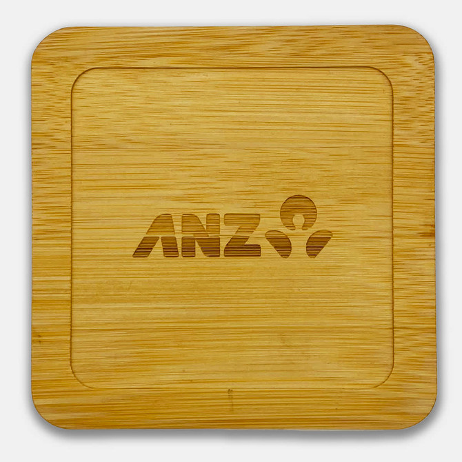 A bamboo coaster featuring a square shape with a logo engraved in the centre.