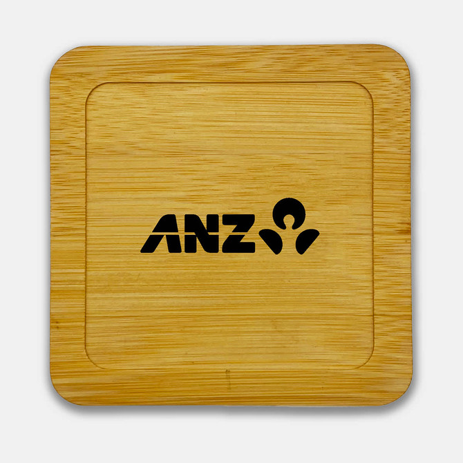 A bamboo coaster featuring a square shape and a black logo. The surface is smooth and polished.