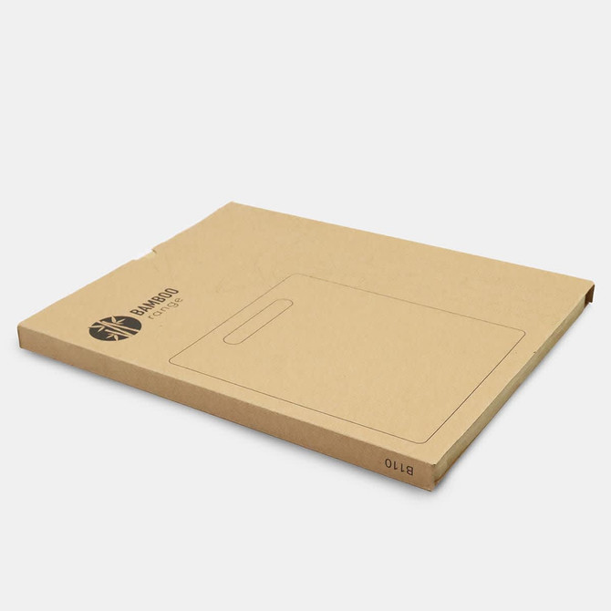 A bamboo chopping board in environmentally friendly packaging, featuring a handle and a simple design.