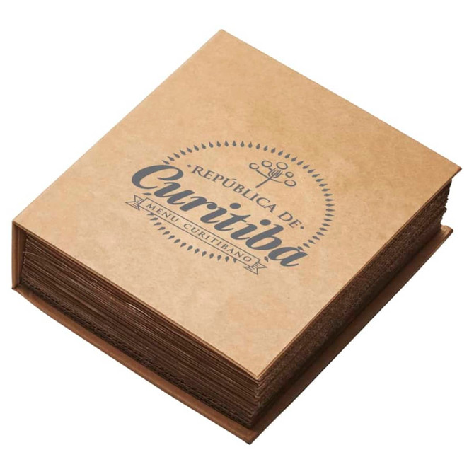 A square menu book with a textured brown cover and stylish black lettering. It has an emblem and decorative design elements.