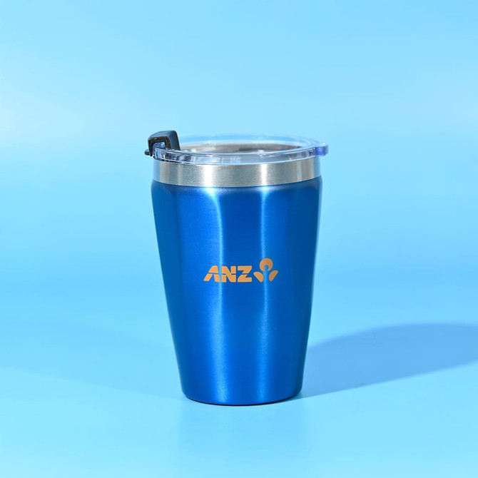 A drink bottle that is a blue stainless steel tumbler with a clear lid and a logo on the front.