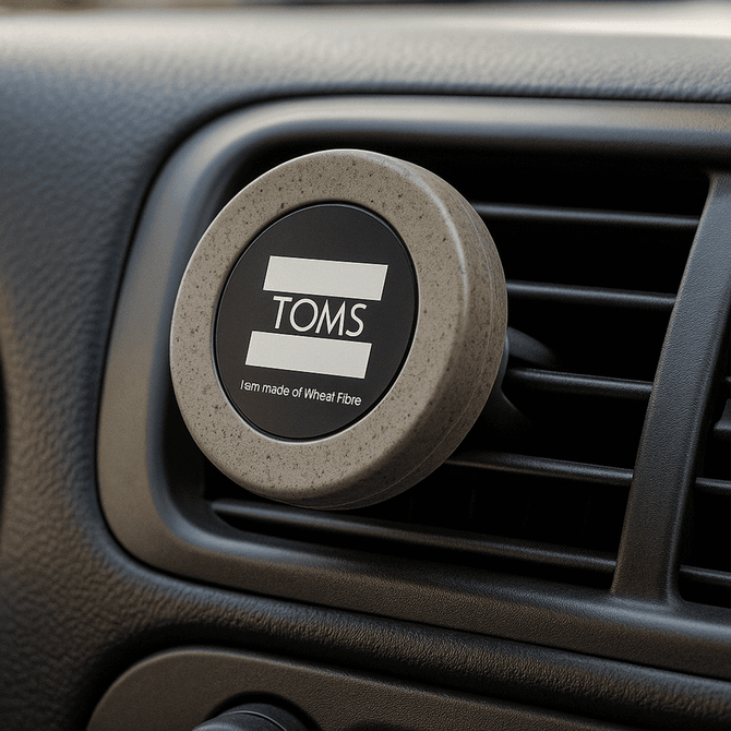 A round, grey magnetic car vent mount with a logo, designed for holding phones.