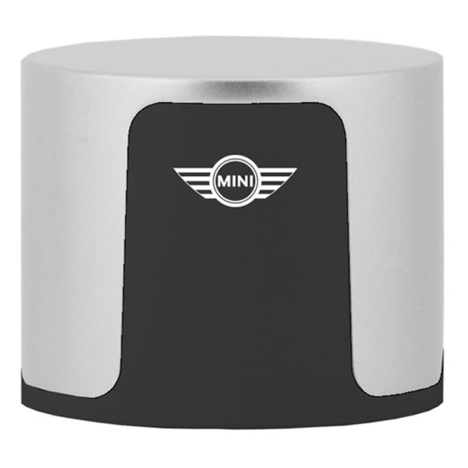 A compact wireless speaker in silver and black with a logo on the front.