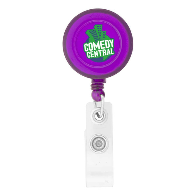 A round badge holder in purple with a clear clip and a logo on the front.