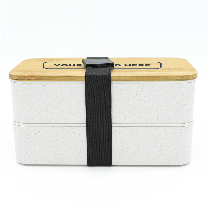 A two-layer lunch box in white with a bamboo lid, secured by a black strap. It features a logo on the top.