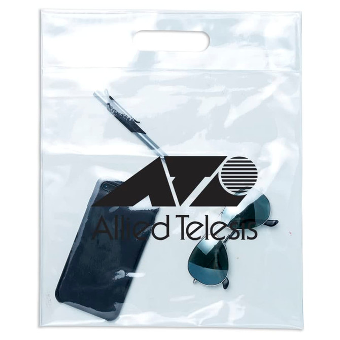 A clear tote bag contains a phone, sunglasses, and a pen, featuring a logo on the front.