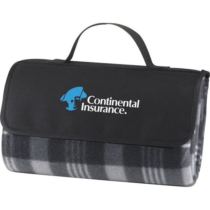 A grey and black checkered picnic rug with a black carrying handle and a logo on the front.