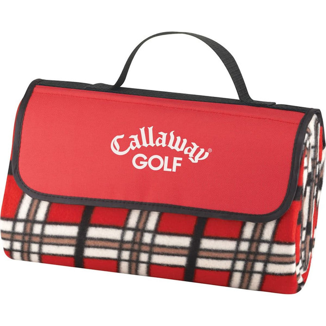 A red picnic rug with a tartan pattern, featuring a carrying handle and a logo.