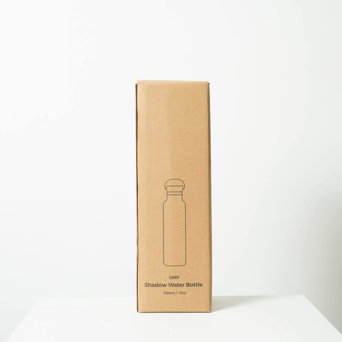 A drink bottle packaged in a simple cardboard box, featuring a minimalist design and a round lid.
