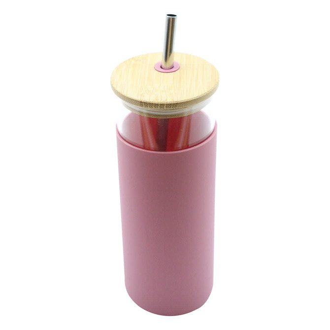 A drink bottle in a soft pink colour with a bamboo lid and metal straw, featuring a clear body.