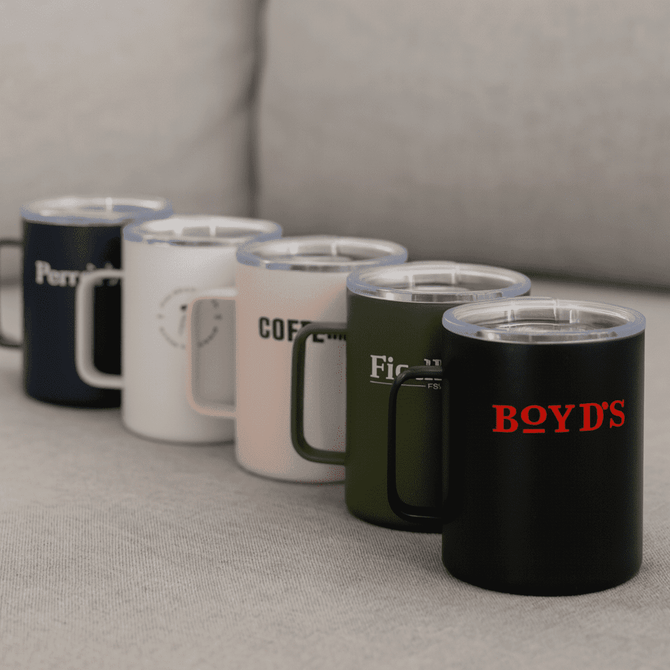 A collection of five travel mugs in navy, white, blush, olive, and black, featuring various logos.