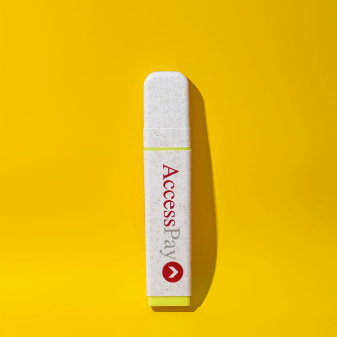 An eco-friendly highlighter in white with a yellow end, featuring a logo on a bright yellow background.