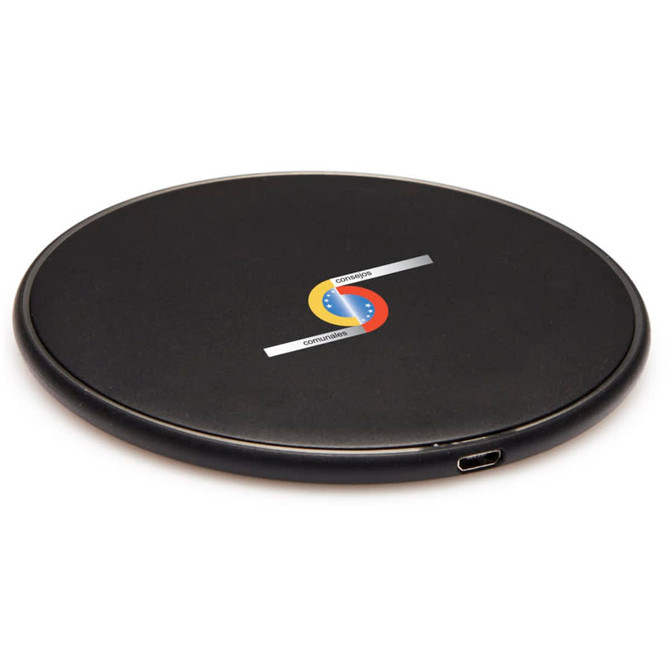 A round black wireless charging dock with a logo and a USB-C port.