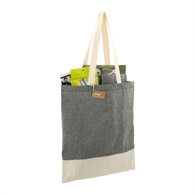 A grey and cream tote bag with a natural fabric texture, featuring a logo and items inside.