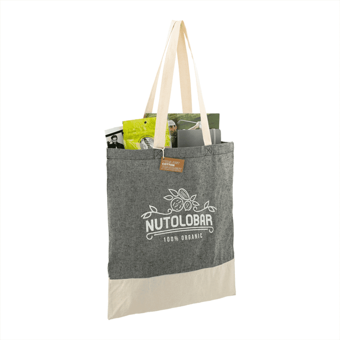 A grey and cream tote bag made from recycled cotton twill, featuring a logo and filled with various items.