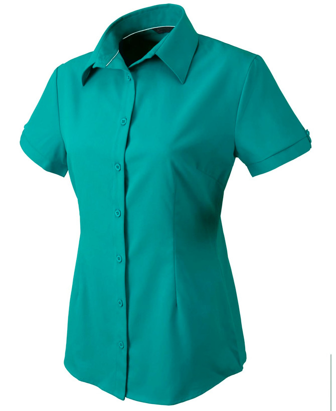 A short-sleeved button-up shirt in teal, featuring a collar and a single breast pocket. It has a logo displayed.