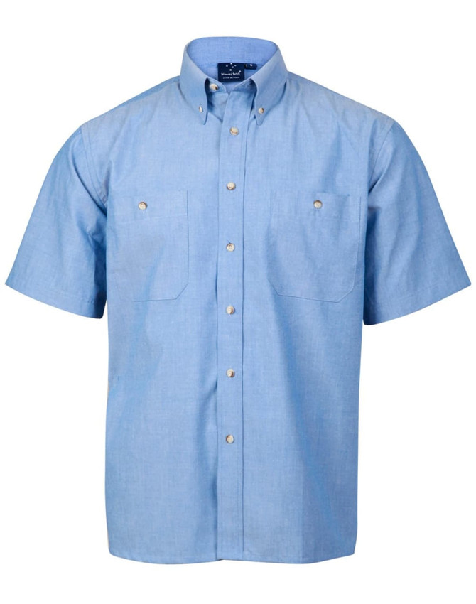 A short-sleeve button-up shirt in light blue chambray with two front pockets and a collar, featuring a logo.