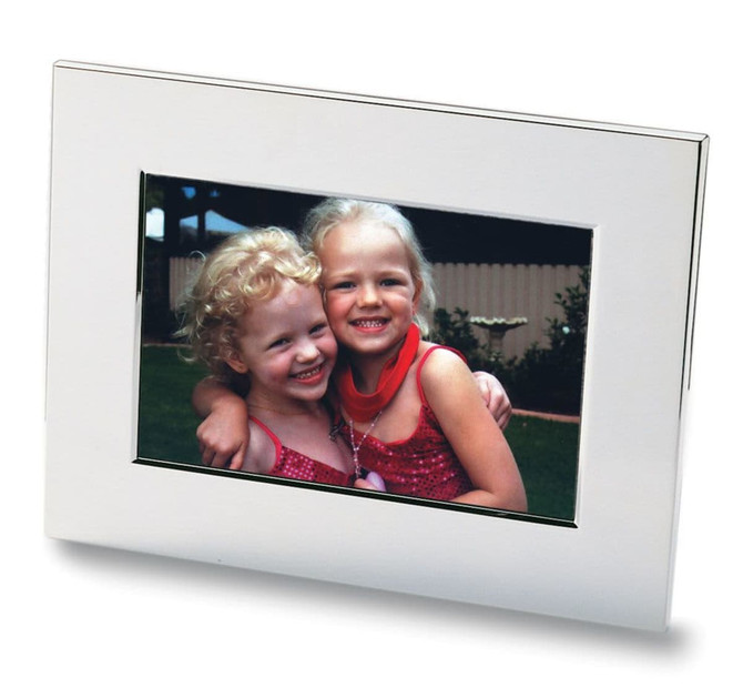A nickel-plated photo frame featuring a vibrant image of two smiling girls with curly hair.