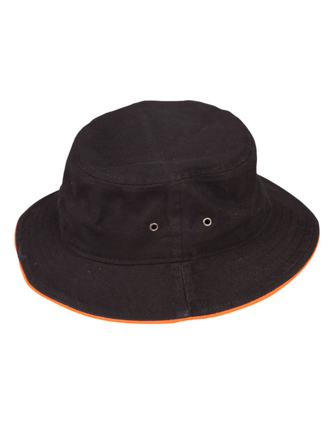 A black bucket hat with a contrast orange trim and eyelet vents. It features a logo on the side.