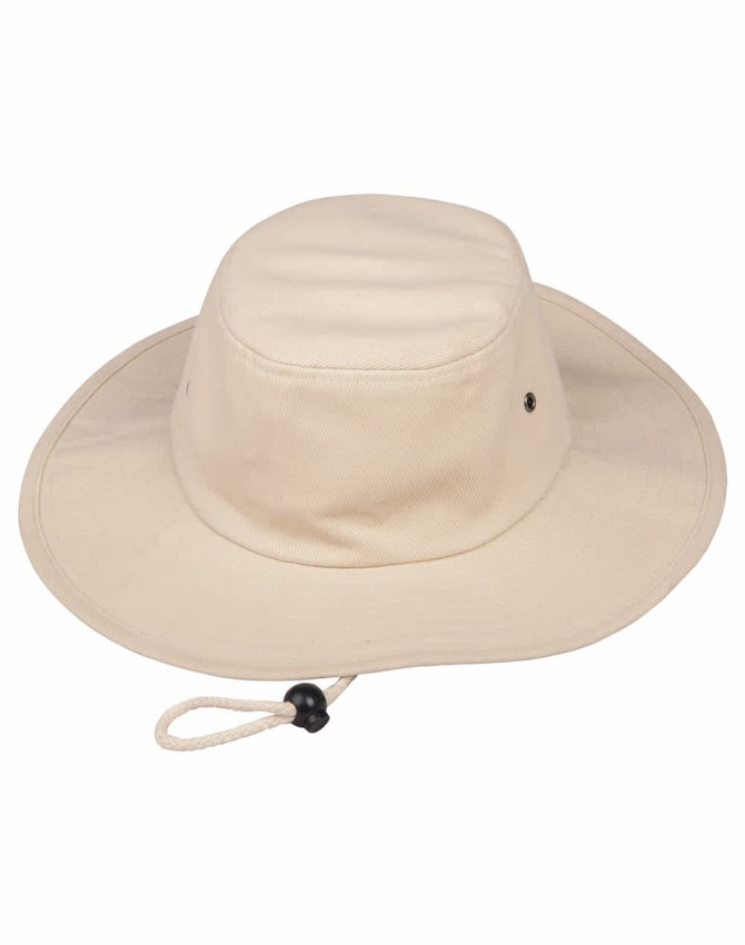 A beige bucket hat with a wide brim and a chin strap, featuring a logo on the side.