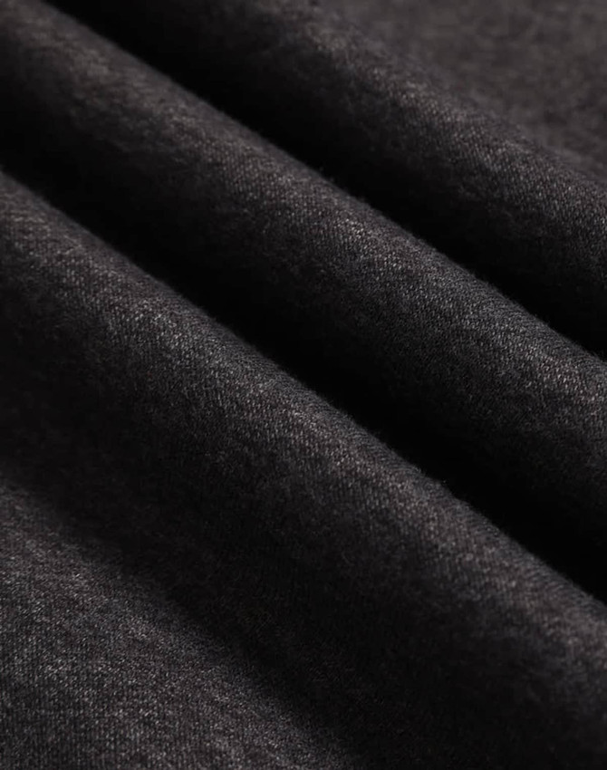A close-up of dark grey polar fleece fabric with a soft, textured surface.