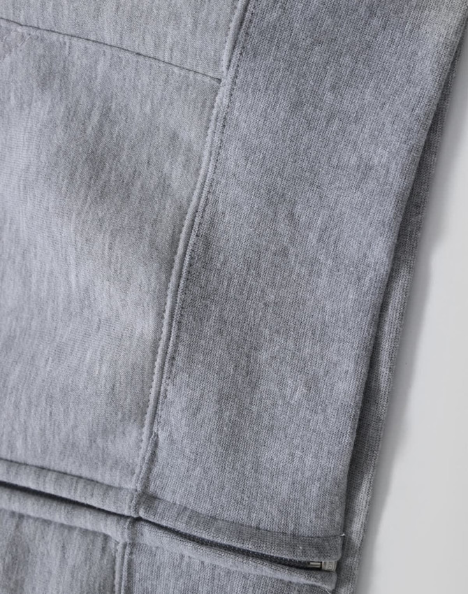 A grey men's full-zip fleecy hoodie with visible stitching details and a smooth fabric texture. Features a logo.