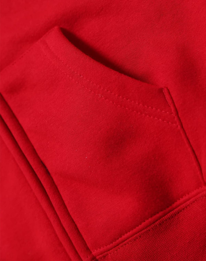 A close-up of a red full-zip fleecy hoodie featuring a front pocket. The fabric appears soft and cozy.