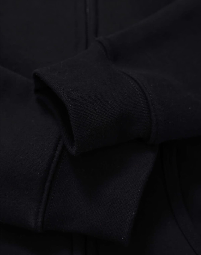 A black full-zip fleecy hoodie with a smooth fabric texture and a close-up view of the sleeve.