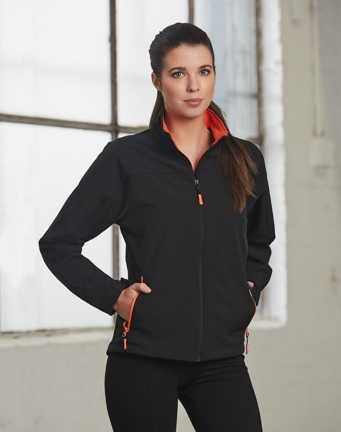 A black softshell jacket with orange contrast detailing, featuring a zippered front and pockets.