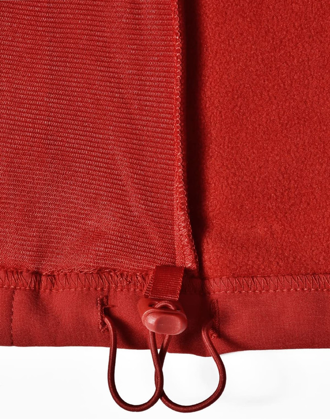 A red softshell vest featuring a drawstring adjuster at the hem and a smooth textured fabric.
