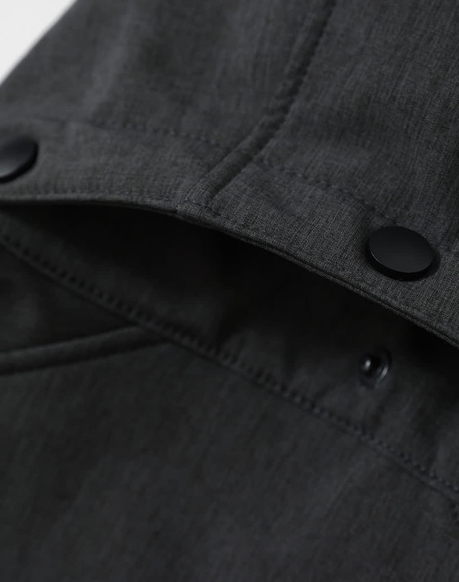 A men's softshell full zip hoodie in grey, featuring a hood and a logo on the inner collar.